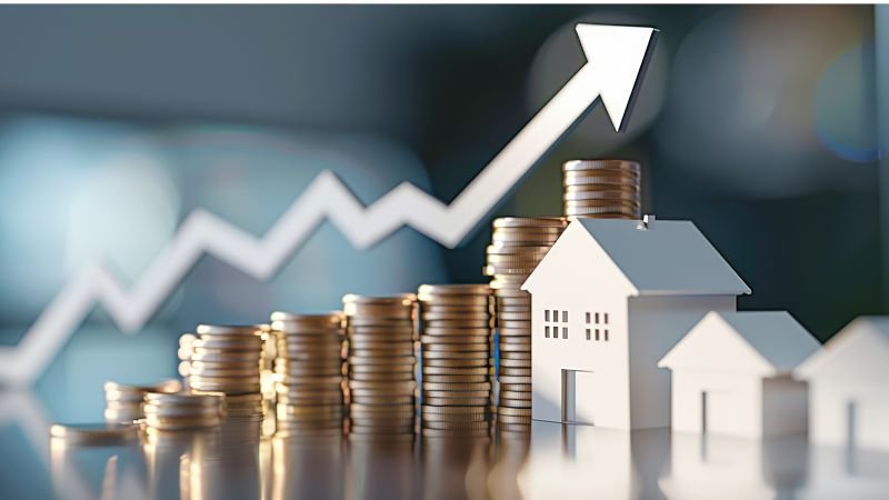 House model with stacked coins and an upward arrow symbolizing real estate investment growth