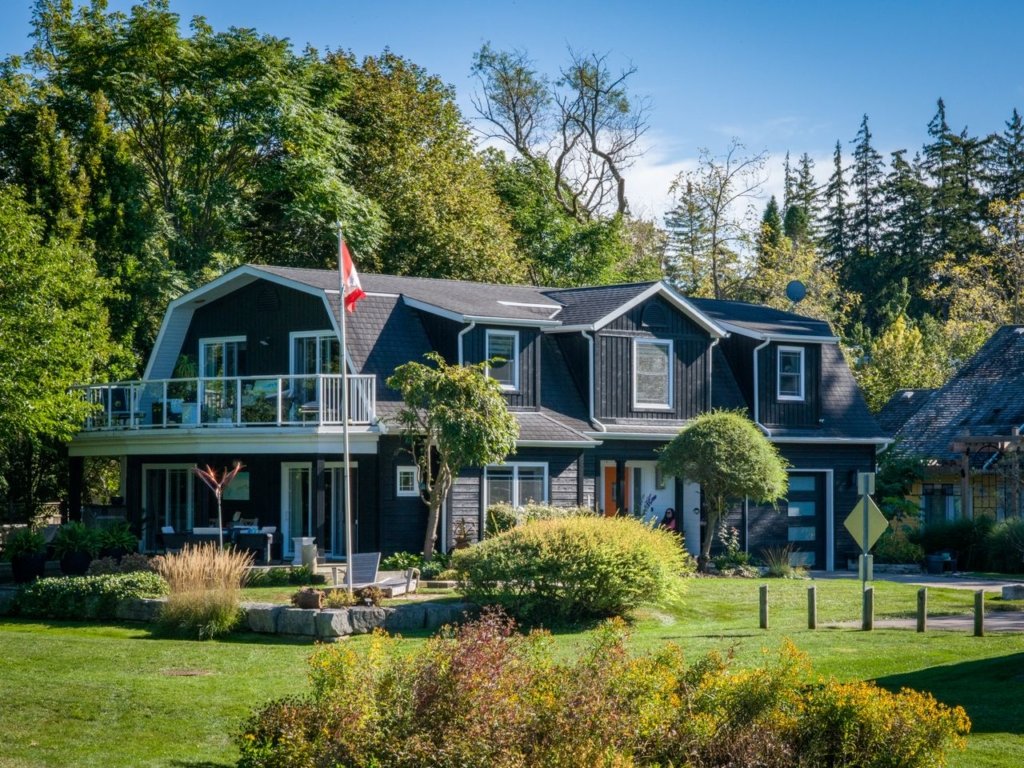 a picturesque Canadian suburban house with vibrant garden under clear blue sky